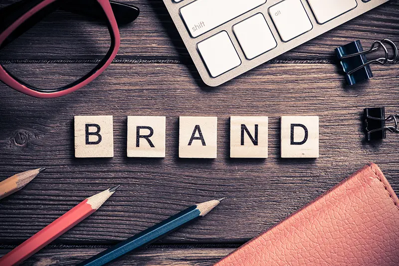Small business branding concept showing cohesive logo, colors, and website design elements aligned across digital and print marketing.